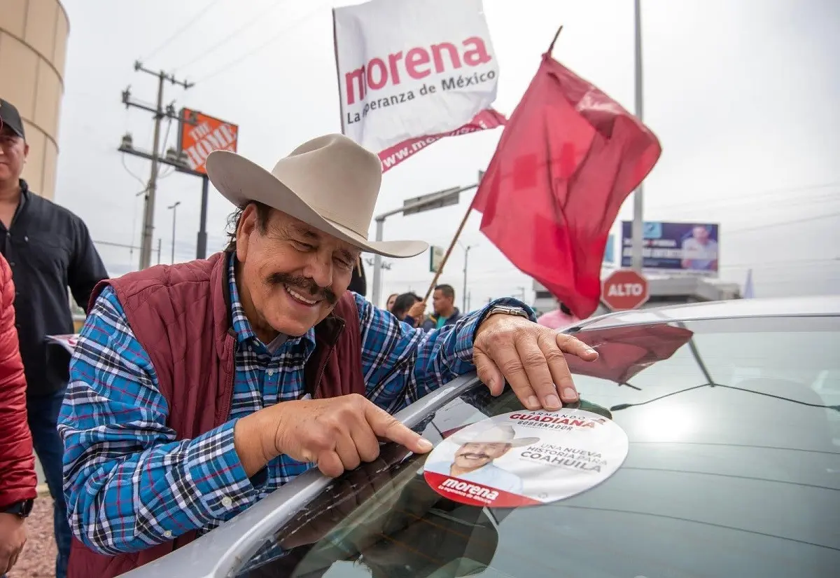 El precandidato de MORENA a la gubernatura de Coahuila, Armando Guadiana Tijerina, colocó calcas en vehículos durante su visita a Torreón, Coahuila. Foto: Facebook Armando Guadiana