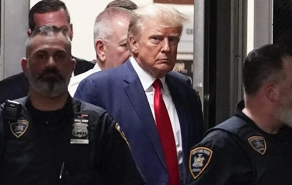 El expresidente Donald Trump es acompañado hacia la sala de un tribunal, el 4 de abril de 2023, en Nueva York. (AP Foto/Mary Altaffer, Archivo)