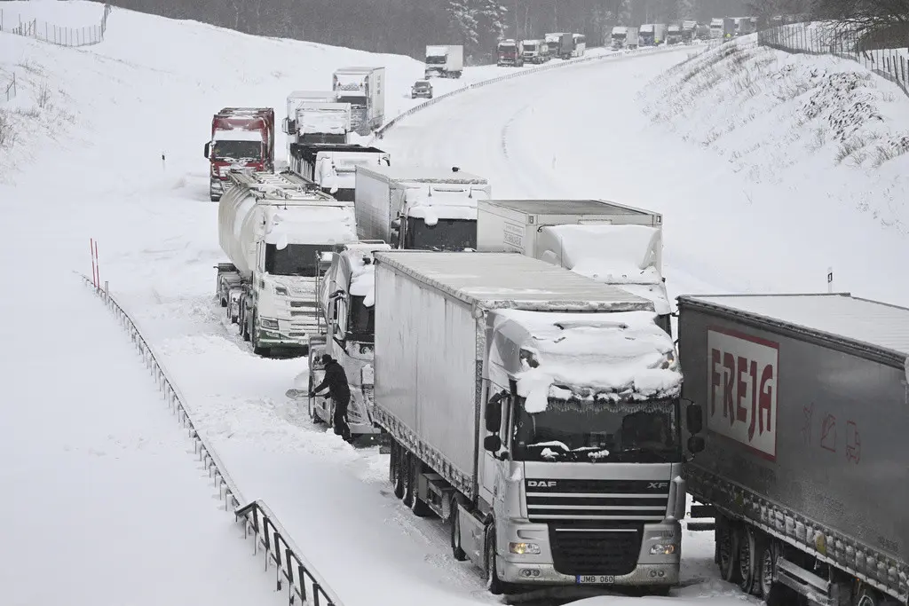 Una fila de camiones, atascados en la autopista E22 a la altura de Linderöd, en el sur de Suecia, debido a una nevada, el 4 de enero de 2024. (Johan Nilsson/TT News Agency vía AP)