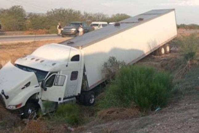 El tráiler que trasladaba a los migrantes tras haber volcado en la carretera. Foto: Periódico Noreste.