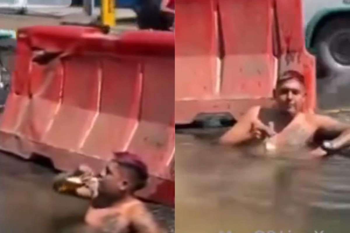 Hombre dentro de bache con agua.    Foto: Captura de pantalla