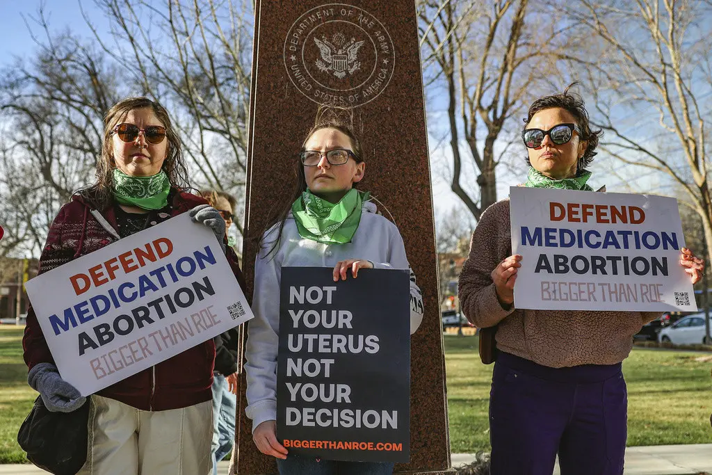 Tres miembros del grupo Womens March protestan en apoyo al acceso a la píldora abortiva frente al Tribunal Federal el miércoles 15 de marzo de 2023 en Amarillo, Texas. (Foto AP/David Erickson, Archivo)