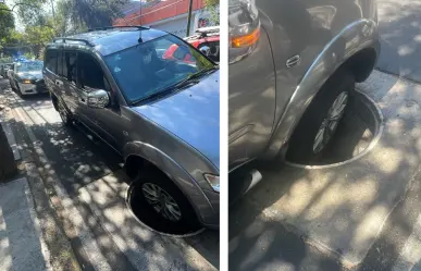 Coladera sin tapa provoca daños a dos vehículos en Cuauhtémoc