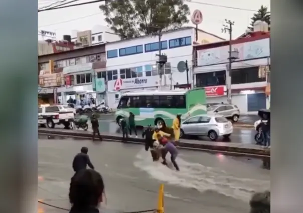 VIDEO | Motociclista es arrastrado por lluvia en CDMX y la gente se une para ayudarlo
