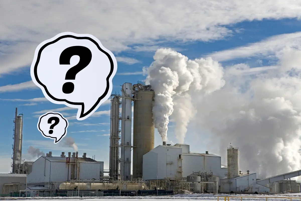 Una empresa contaminando y signos de pregunta. Foto: Canva
