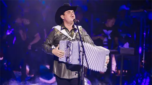 Alfredo Olivas regala uno de sus acordeones a un pequeño fanático Alfredo Olivas regala uno de sus acordeones a un pequeño fanático